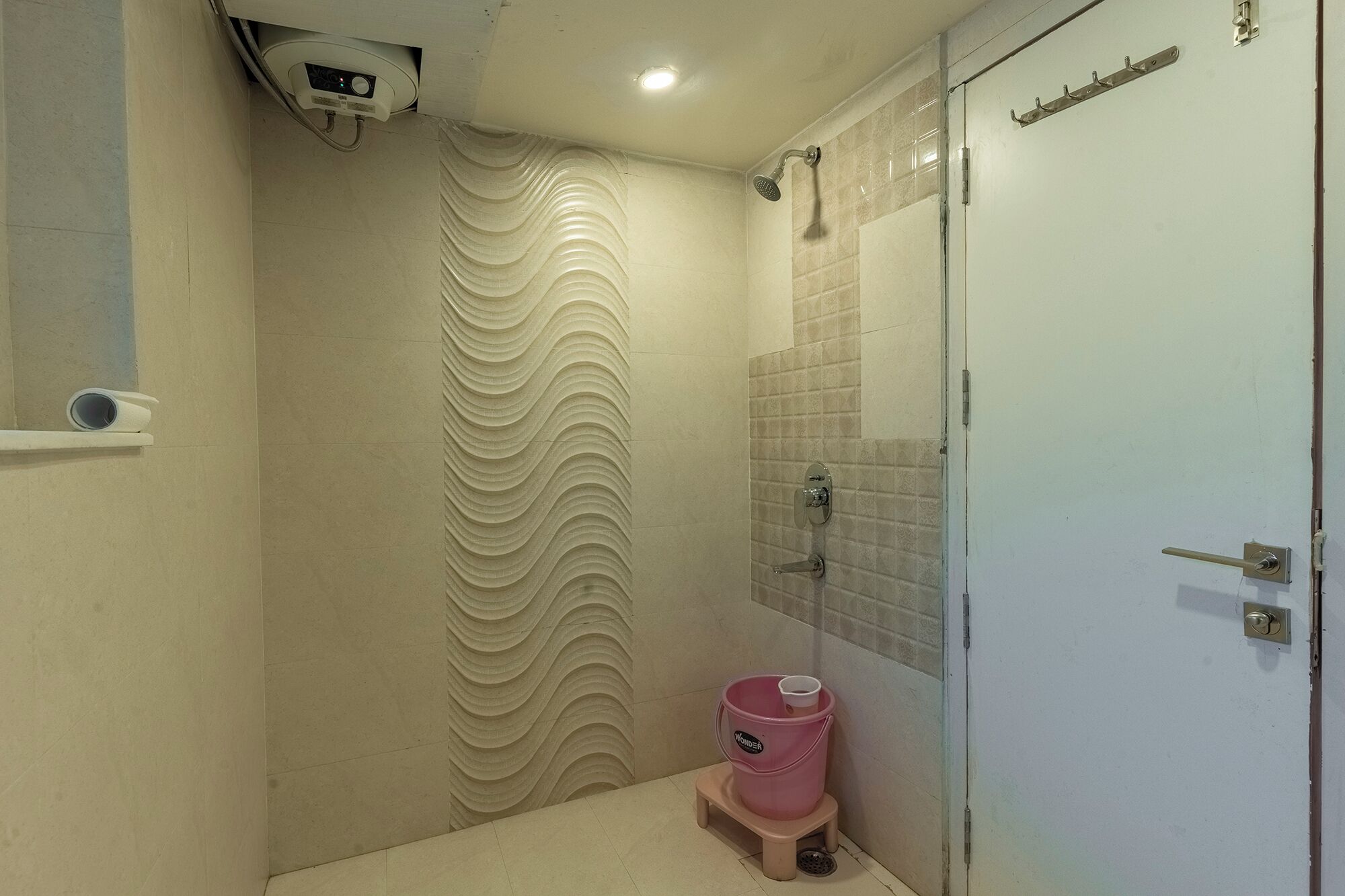 A bathroom with a shower, a toilet, and a sink.