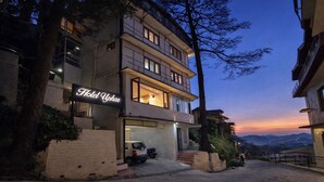A multi-story hotel with a sign reading 'Hotel Upar.' - Kavin Uphar - The Mall (Shimla)