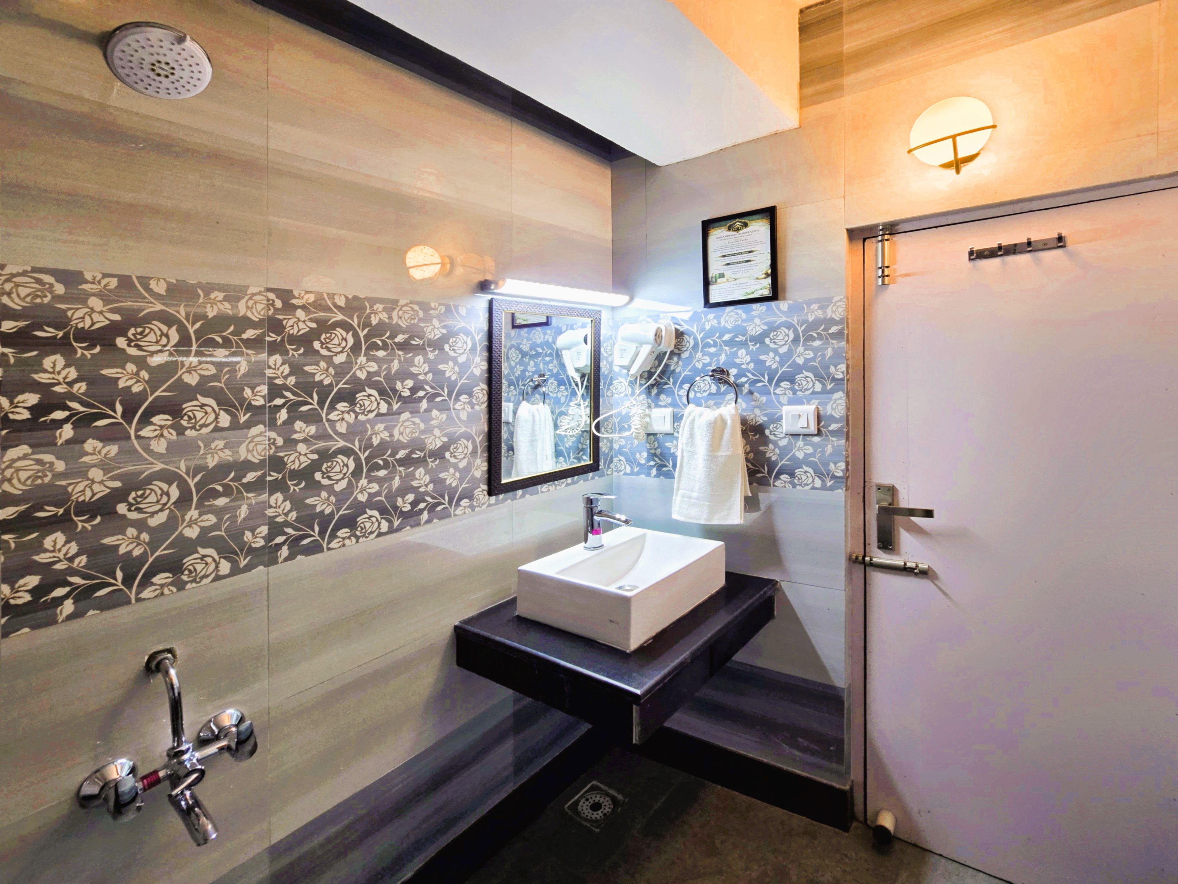A modern bathroom with a vanity, a shower, and a toilet.
