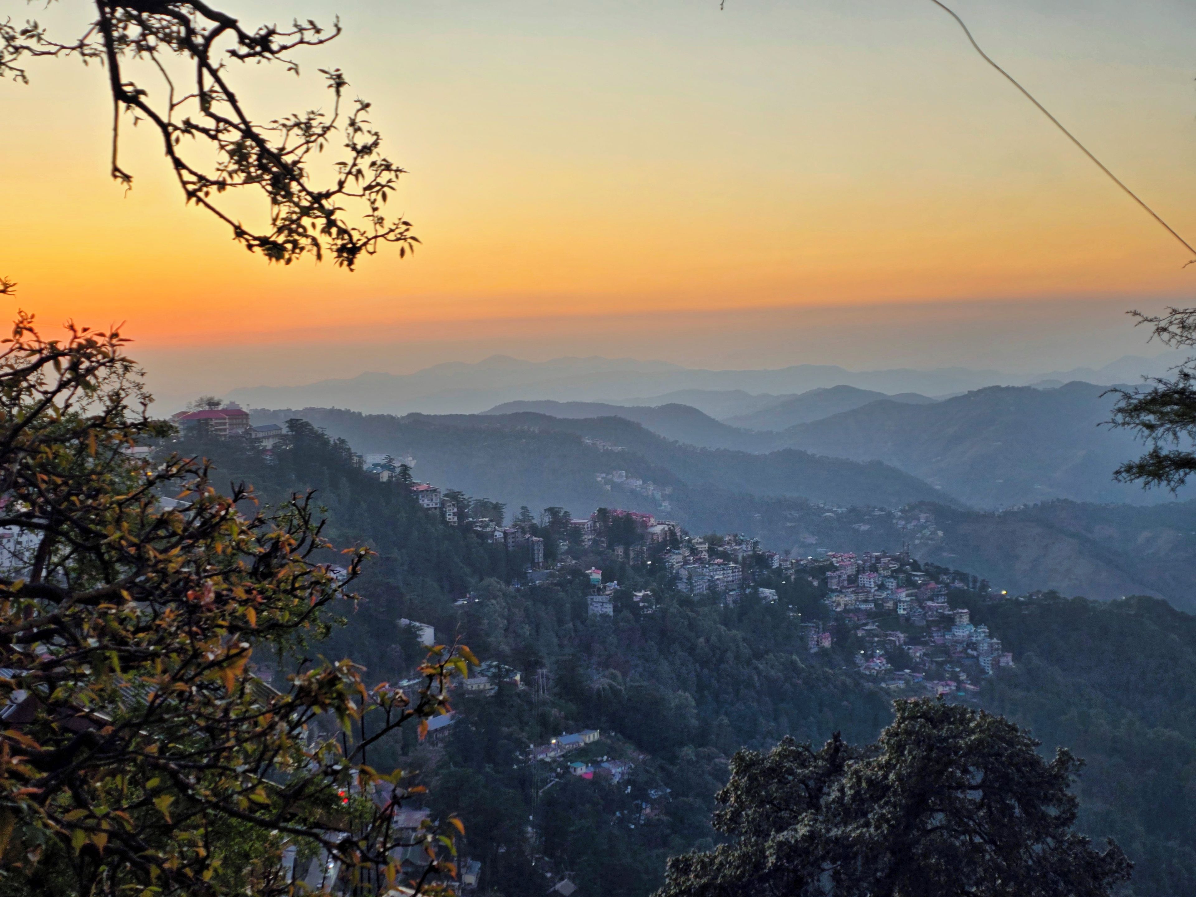 A panoramic view of a mountainous landscape with a town nestled among the hills.