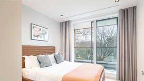 Una camera da letto con un letto, una finestra e vista sugli alberi.