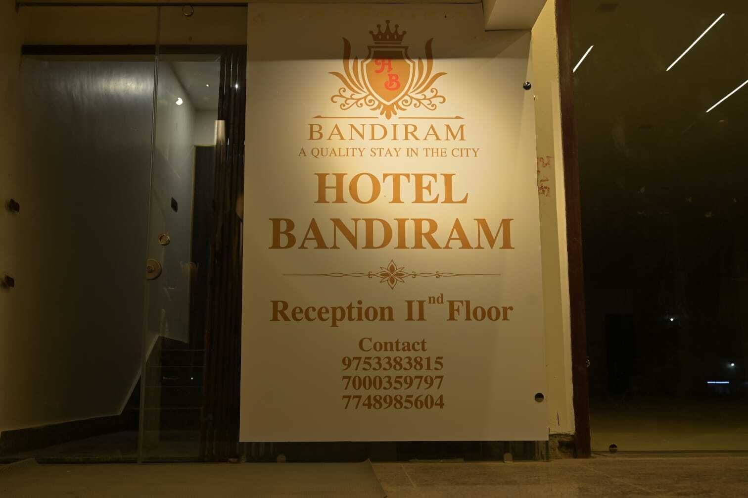 A hotel sign for Bandiram on the Reception IInd Floor with contact numbers.
