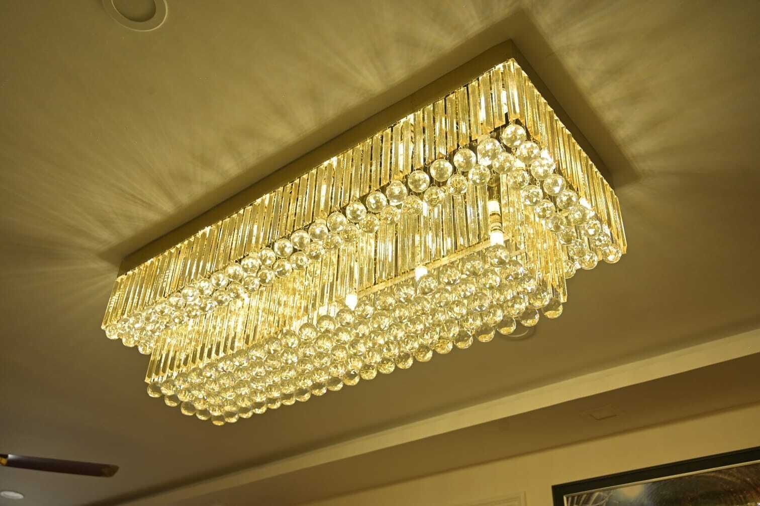 A chandelier with multiple tiers of crystal and gold accents.