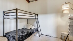 A bunk bed with a ladder, a white lamp, and a small stool. - Bay Area Family Home w/ Indoor Pool + Game Room (South San Francisco)