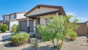 A residential house with a garage, a covered porch, and a gravel driveway. - Near Golf, Parks & Casino! Updated Maricopa Home (Maricopa)