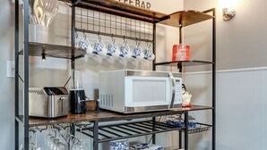 A kitchen with a coffee bar, microwave, utensils, and dishes. - Warren County Launchpad: Pet-friendly Lebanon Apt (South Lebanon)