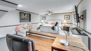 A bedroom with a bed, bedside tables, a desk, a chair, a ceiling fan, and a TV mounted on the wall. - Escape to Nature! Cozy Blue Ridge Mtn Retreat (Epworth)