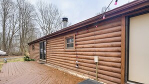 A log cabin with a deck, a chimney, and a window. - Quiet Wooded Escape! Metro Detroit Basecamp (Romulus)