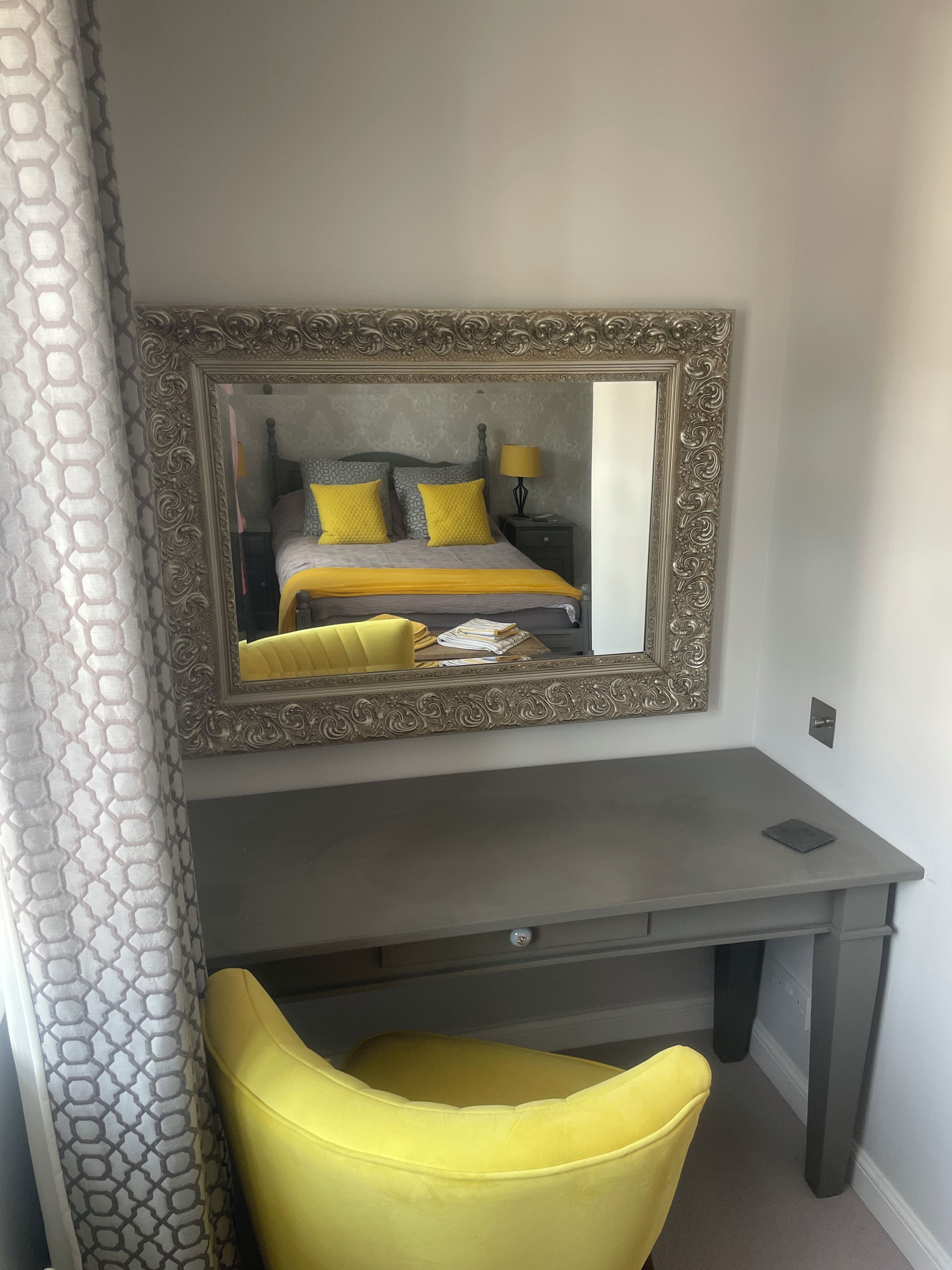 A room with a bed, a desk, and a chair.