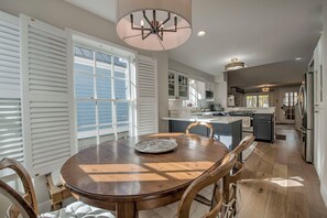 A spacious kitchen with a dining area, large windows, and a central island. - French Street Chalet - Downtown Breckenridge, 30+ Day Rental (Breckenridge)