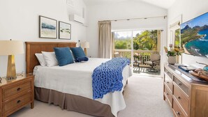 A bedroom with a bed, nightstand, dresser, and a ceiling fan. - Poipu Kai - 6BR Ocean View, 2 Condos - Sleeps 16 (Koloa)