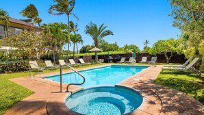 A swimming pool with a hot tub, surrounded by lounge chairs and palm trees. - Poipu Kai - 6BR Ocean View, 2 Condos - Sleeps 16 (Koloa)