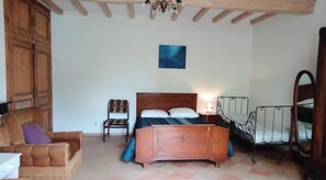 A bedroom with a wooden bed, a chair, a bedside table, and a mirror. - Gite des salesses, fun with family and friends (Gaillac)