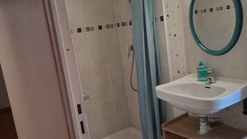 Shower, hair dryer, soap, toilet paper