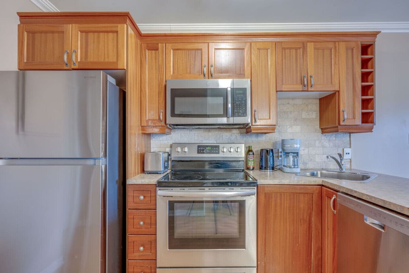 Fridge, dishwasher, coffee/tea maker, cookware/dishes/utensils