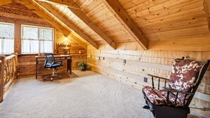 A log cabin interior with a desk, office chair, and a patterned armchair. - Caney Creek Retreat 1 Bedroom Cabin (Cosby)
