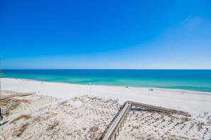 A beach with a wooden boardwalk, sandy dunes, and a clear blue sky. - Wind Drift 604s 2 Bedroom Condo (Orange Beach)