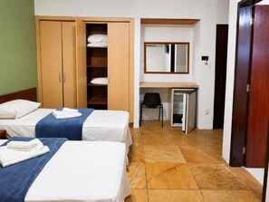 A hotel room with two beds, a wardrobe, a desk with a chair, and a mirror. - HANNA Marina's Palace Hotel (Florianópolis)