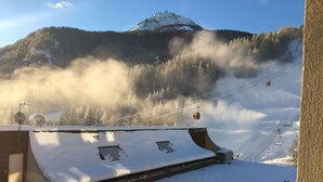 A snow-covered building with a ski lift in the background. - Studio for 4 in Serre-Chevalier, Southeast Balcony (Saint-Chaffrey)
