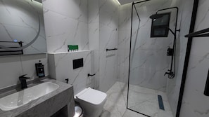 A modern bathroom with a marble sink, toilet, and shower. - 004 Tara-jre Jabal Al Lweibdeh With Stunning View (Amman)