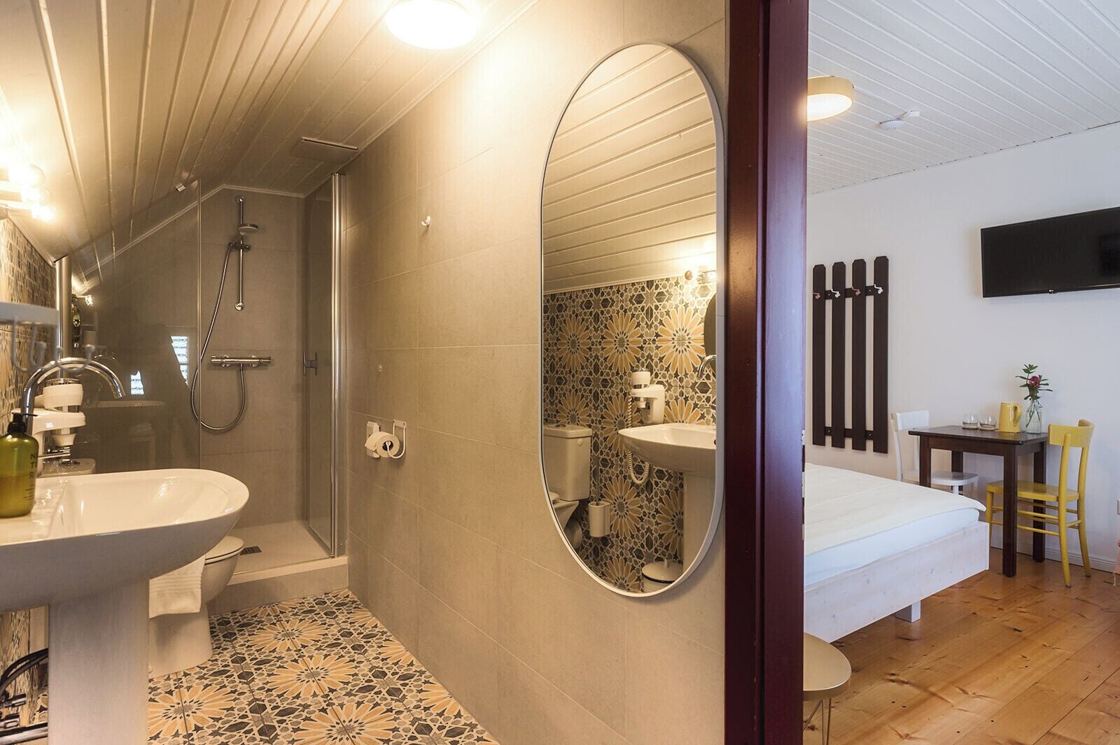 A modern bathroom with a shower, sink, and toilet.
