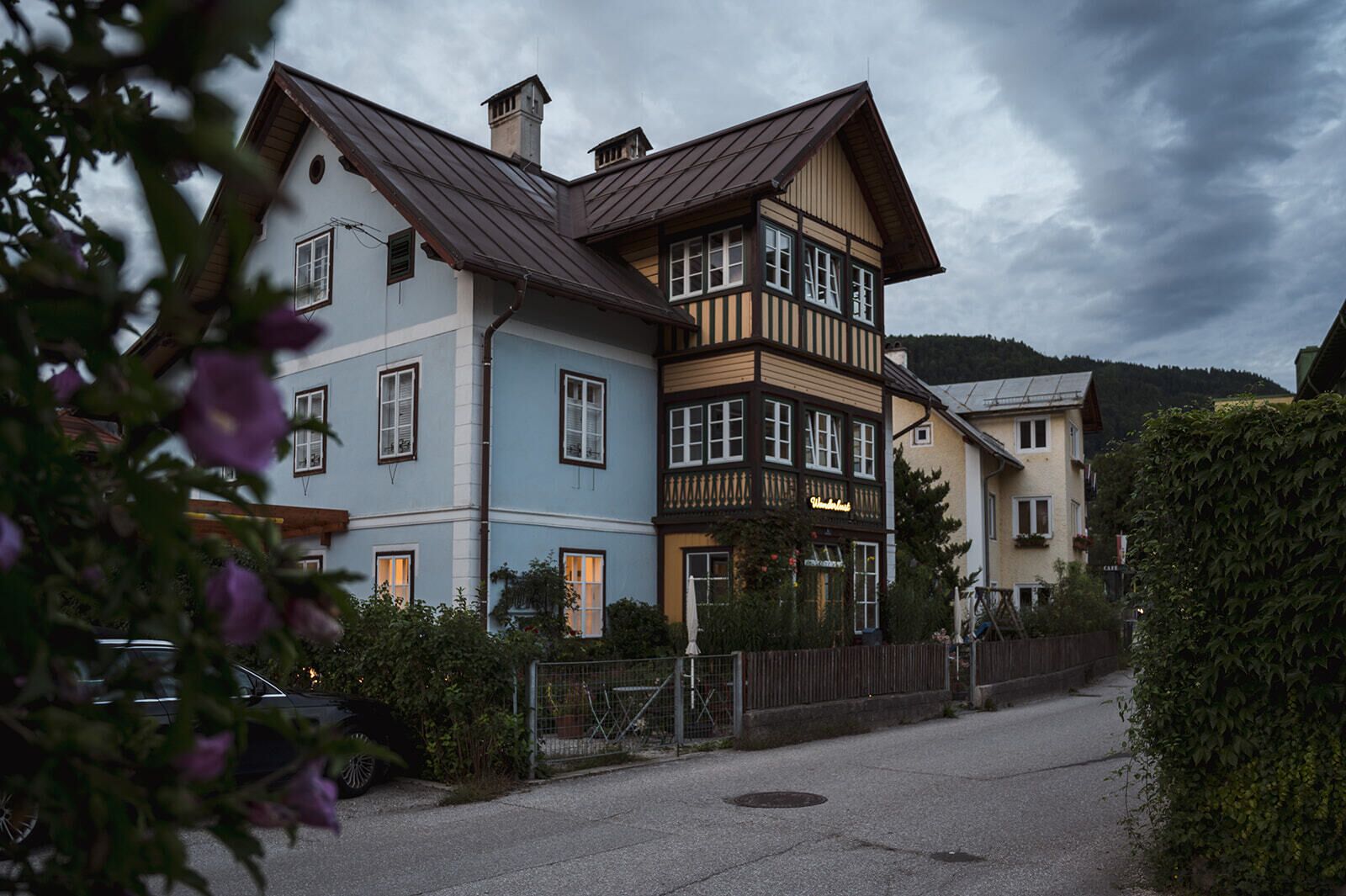 A multi-story building with a traditional architectural style, featuring a mix of wooden and stone facades, and a prominent balcony on the upper floor.