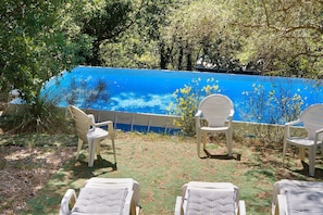A poolside area with lounge chairs and a pool.