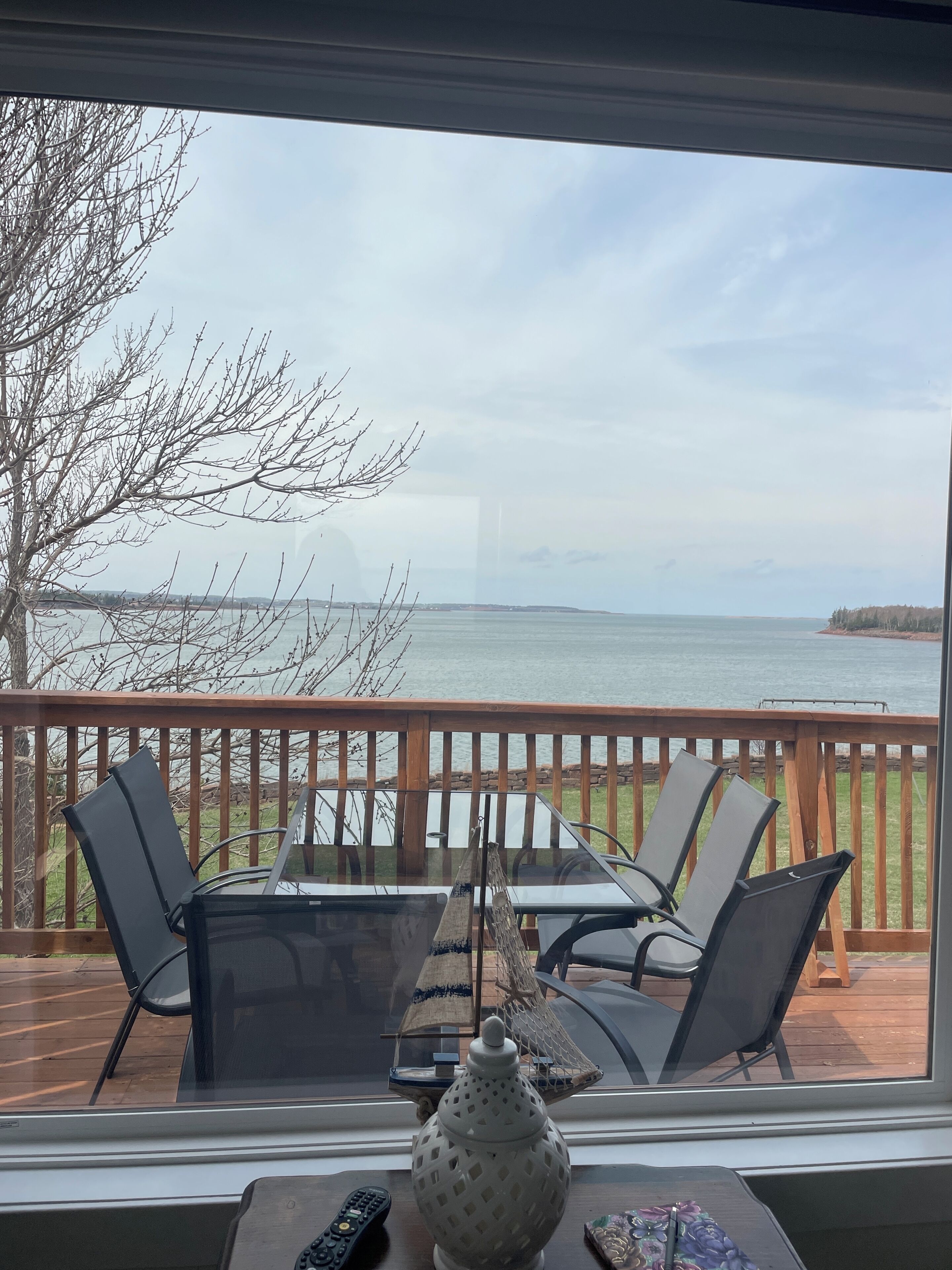 A deck with a table and chairs, a lamp, and a decorative item.