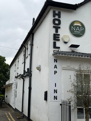 A white building with a sign reading 'HOTEL NAP INN' and a logo for 'NAP BARNET' with a phone number. - Nap Barnet Hotel (Barnet)