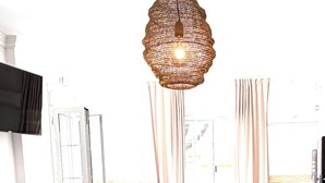 A restaurant interior with tables and chairs, a hanging light fixture, and a television on the wall. - Hotel Victoria Matalascañas (Matalascañas)