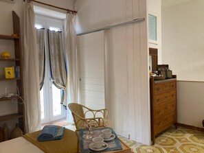 A room with a bed, a chair, a dresser, and a window with curtains. - Casa dell'Orologio - Two Bedroom Apartment, Sleeps 4 (Palazzolo Acreide)
