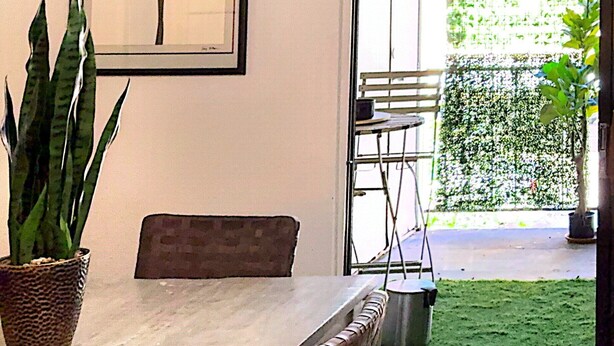 An indoor dining area with a table, chairs, a potted plant, and a framed artwork on the wall. - A comfortable, restful stay designed for doctors and Medical Professionals (Houston)