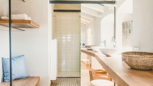 A modern bathroom with a geometric patterned floor, a wooden bench, and a large woven bowl on the counter. - Villa Cervia - Six Bedroom Villa, Sleeps 15 (Cervià de Ter)