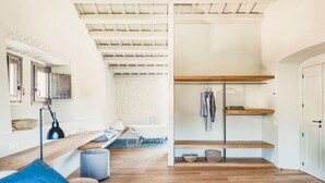 A modern bedroom with a bed, a desk, a chair, a hanging light, and a wardrobe. - Villa Cervia - Six Bedroom Villa, Sleeps 15 (Cervià de Ter)