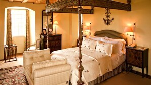 A bedroom with a four-poster bed, a wooden ceiling, a nightstand with a lamp, and a chair. - Fenton Tower - Six Bedroom Villa, Sleeps 12 (Kingston)
