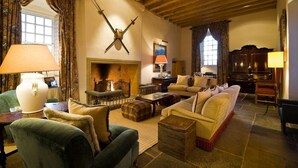 A cozy living room with a fireplace, wooden beams, and comfortable seating. - Fenton Tower - Six Bedroom Villa, Sleeps 12 (Kingston)