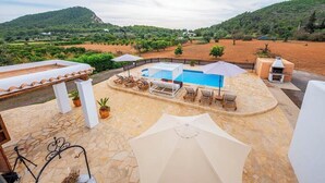 A rooftop pool with lounge chairs, a pergola, and potted plants. - Casa Cala LLonga family house 850 m from the beach (Eivissa)
