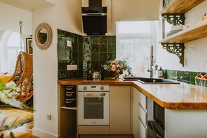 A compact kitchen with a built-in oven, a microwave, and a sink. - Resonance - One Bedroom Villa, Sleeps 2 (Portpatrick)