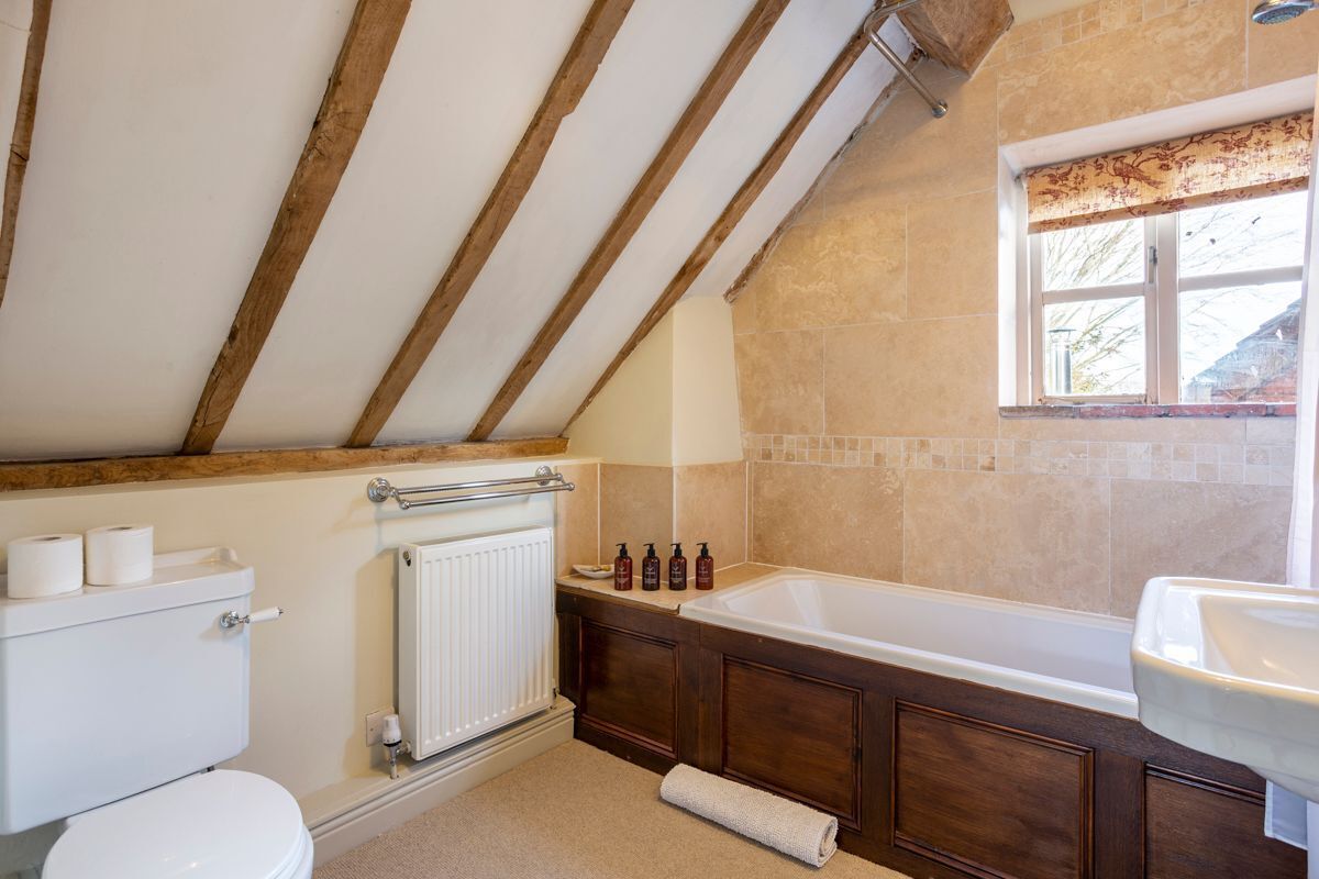 A bathroom with a bathtub, a toilet, and a sink.