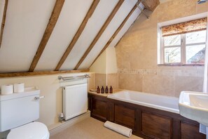 A bathroom with a bathtub, a toilet, and a sink. - Chevaliers Cider House (Upton Cressett)
