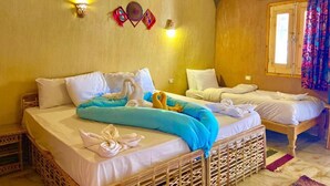 A room with two beds, a brick ceiling, and a window with curtains. - Kabara (Abu Simbel)