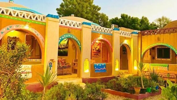 A courtyard with traditional architecture, including arches and a tiled roof. - Kabara (Abu Simbel)
