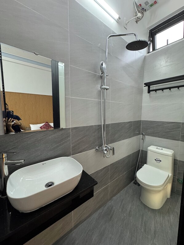 A modern bathroom with a white sink, a shower, and a toilet. - DAI NOI SAPHIA HOMESTAY (Hue)