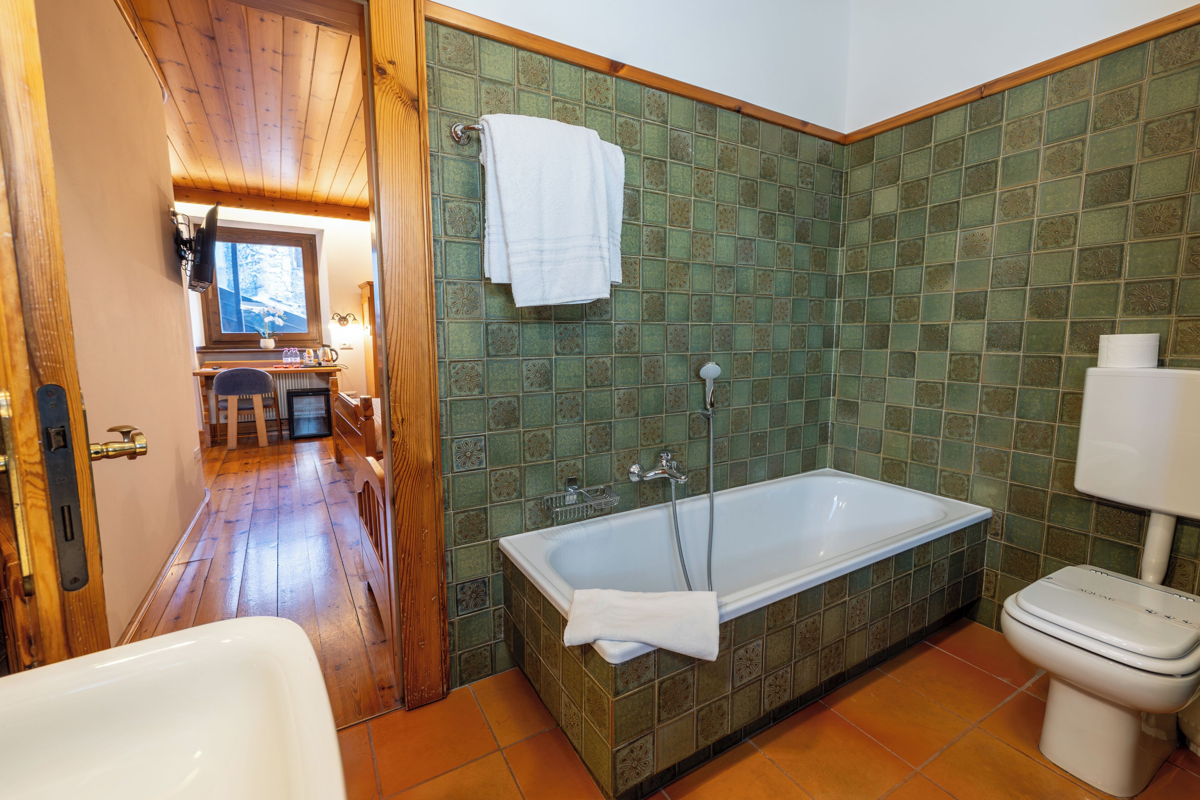 A bathroom with a bathtub, toilet, and a shower.