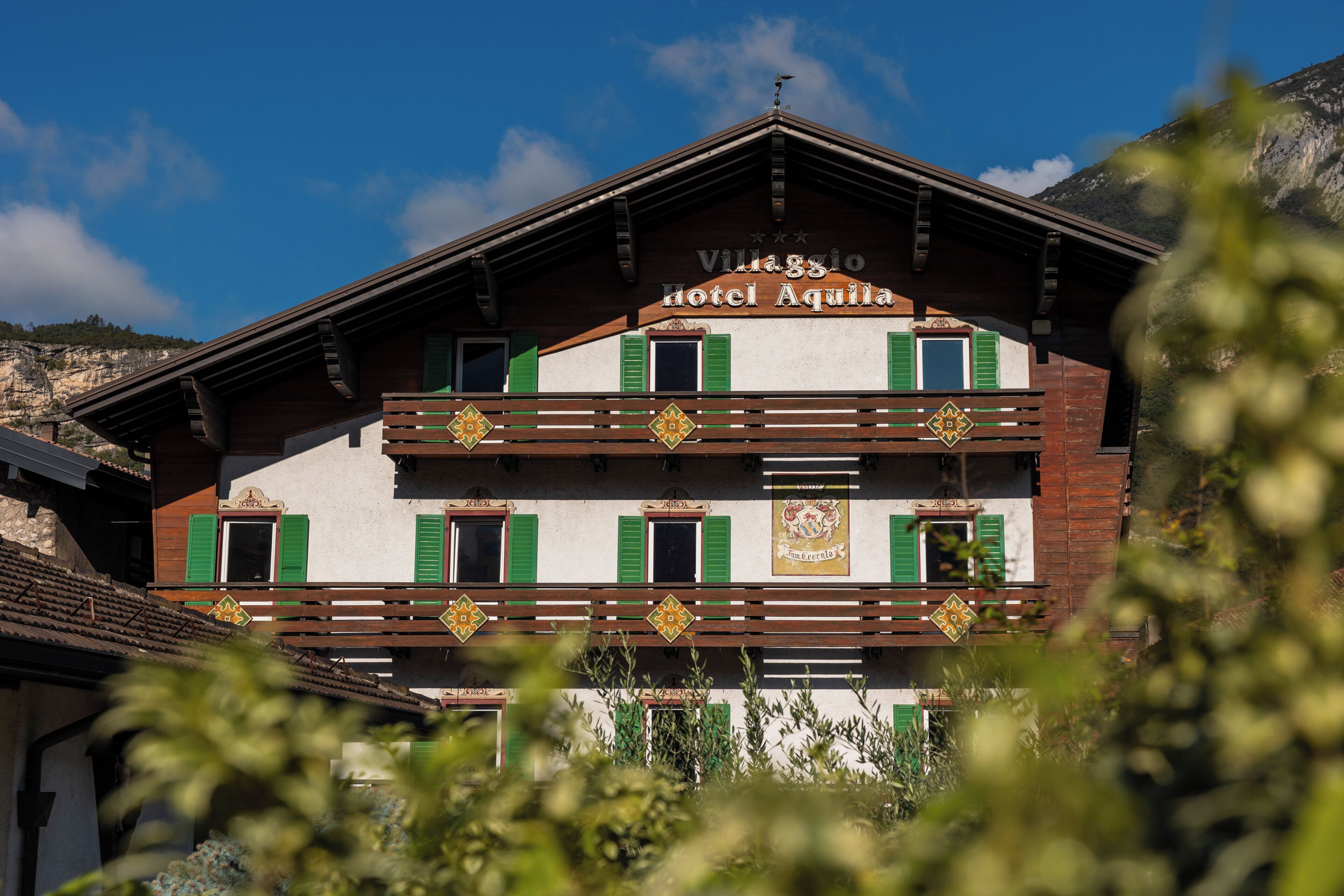 A two-story building with a sign reading 'Villaggio Hotel Aquila.'