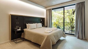 A modern hotel room with a large bed, a nightstand, a window with a view of greenery, and a balcony. - Portal Arévalo in Palermo by Magno | 21 (Buenos Aires)