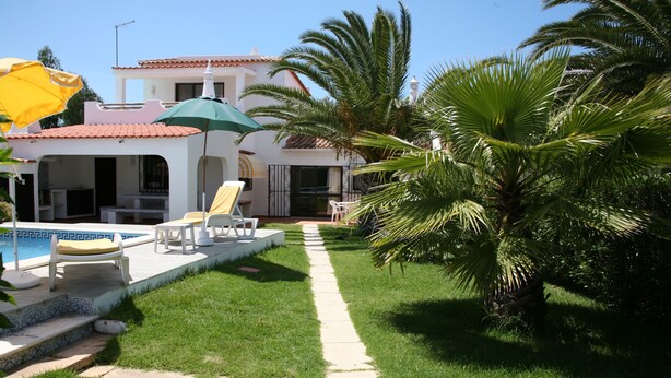 A pool area with lounge chairs and umbrellas, a pathway, and a palm tree. - Country House 'Quinta Da Eira' with Private Pool, Wi-Fi and Air Conditioning (Lagoa)