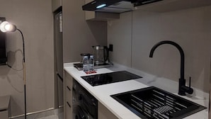 A compact kitchen with a microwave, sink, and dishwasher. - 007s Tara-jre Jabal Al Lweibdeh With Stunning View (Amman)