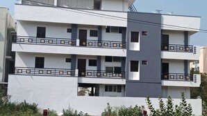 A multi-story building with balconies, a sign indicating it is a residential property, and a clear sky. - Thamira Residency (Palayankottai)