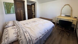 A bedroom with a bed, a desk, a chair, a mirror, and a map on the wall. - 3BR Farmhouse in Durango with Fitness Room, Sauna, Bidets, Theater Entertainment (Durango)